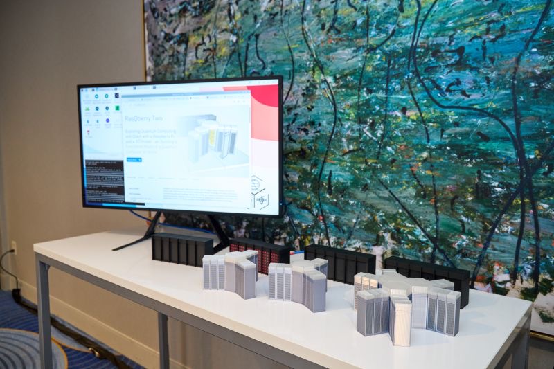 The RasQberry Two stand at QDC 2025: models and a screen with the demos